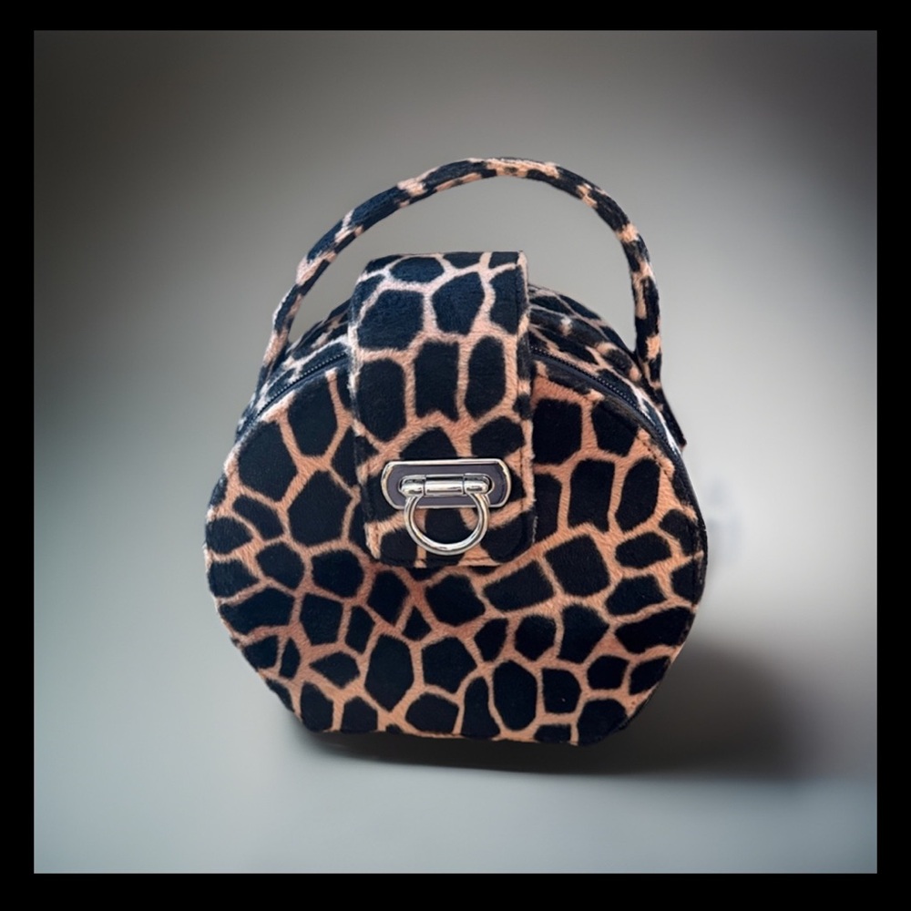 Handbag: Stylish Black and Tan Giraffe Print. Approx 7” x 8”. Large front clasp